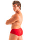 A muscular man with curly brown hair is shown from a side-back angle wearing bright red briefs against a plain white studio background. 