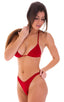 Brazilian Triangle Swim Top  in Black tricot-nylon-lycra 1; Brazilian Triangle Swim Top  in Black tricot-nylon-lycra 1.5; Brazilian Triangle Swim Top  in Black. This image features a striking red Brazilian triangle bikini top, designed with a low Brazilian cut that emphasizes more cleavage. The bikini top is depicted in a solid red color with adjustable cups to accommodate various sizes and preferences.